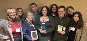 A group of college students from WQSU Susquehanna University posing with plaques from their award